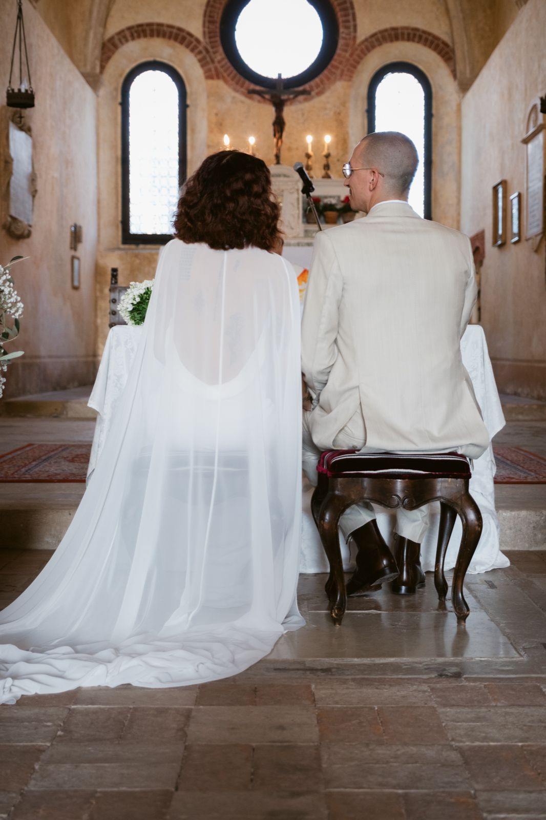 The couple before the altar, beneath the church’s rose window